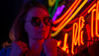 © Anton - Street fashion young girl with sunglasses, neon light red blue, nightlife and trendy lifestyle