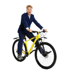 Poster - Young businessman riding bicycle on white background