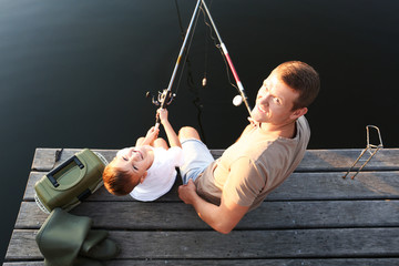 Wall Mural - Dad and son fishing together at lake, above view