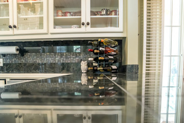 wine bottle storage small compact pool guest house kitchen with cream cabinets and stainless steel appliances