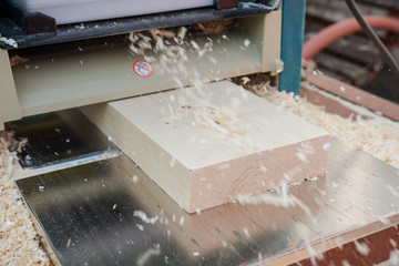 Wall Mural - planing boards on a thicknesser. wood shavings. machine for planing wood. carpentry work. joiner's machine.