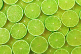 Fototapeta Panele - Fresh lime slices as a background.