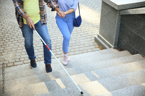 Fotografía Blind mature man with his daughter walking outdoors