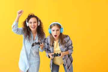 Sticker - Teenagers playing video game on color background