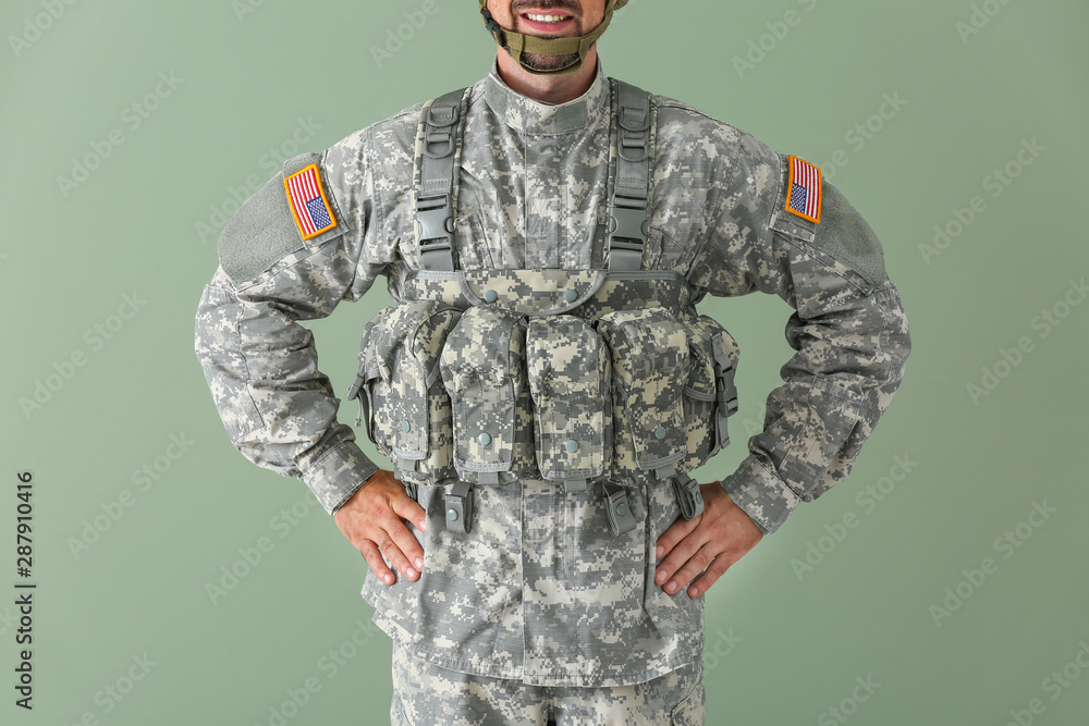 Soldier in camouflage on color background