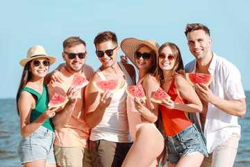 Sticker - Happy friends eating watermelon on sea beach at resort