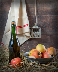 Wall Mural - Bottle of cider with apples on the straw