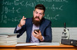 © be free - User experience. School teacher hold mobile phone chalkboard background. Teacher bearded man learn use modern technology. Learn technology. Modern communication. School application. Study technology