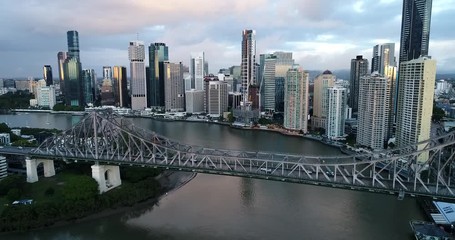 Sticker - High above steel arches of Story Bridge across Brisbane River around Brisbane city CBD high-rise towers in aerial panning.