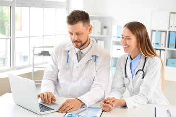 Sticker - Male and female doctors working at table in clinic