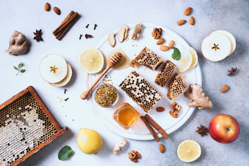 Wall Mural - Ingredients for healthy hot drink. Lemon, ginger, mint, honey, apple and spices on grey concrete background. Copy space. Top view. Alternative medicine concept. Clean eating, detox