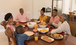 © wavebreak3 - Multi-generation family praying together before having meal