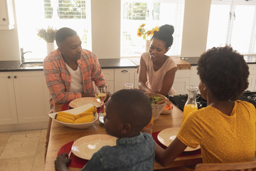 Wall Mural - Happy African American family having food at dining table