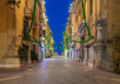 The main city street of the Republic in the light of lanterns at dawn. Valletta.