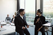 © Maskot - Businesswomen talking with colleagues in conference room