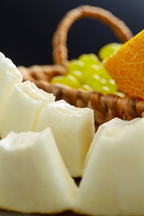 Wall Mural - Slices of ripe sliced melon close-up on a dark background. Vertical image.. Favorite fruit in summer. Food,Fruits or healthcare concept.