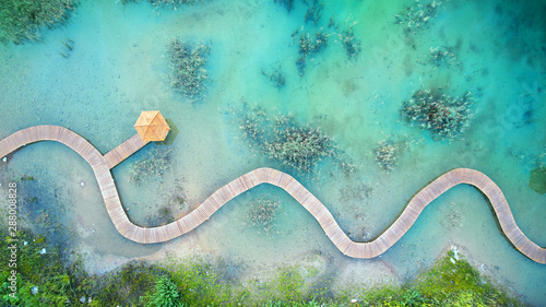 Fotografía Aerial landscape from the drone - blue water and wooden bridge