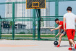 © qunica.com - Basketball players playing ball in the middle of the day