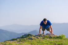 Fit Male Athlete Doing Pushups At The Edge Of A Cliff While Enjoying The Amazing View.