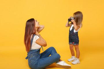 Wall Mural - Woman in light clothes have fun with cute child baby girl 4-5 years old. Mommy little kid daughter isolated on yellow background studio portrait. Mother's Day love family parenthood childhood concept.