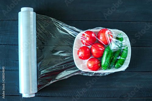 Using food film for vegetables storage in fridge. Top view