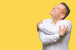 © Krakenimages.com - Middle age arab elegant man over isolated background Hugging oneself happy and positive, smiling confident. Self love and self care