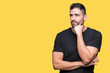 © Krakenimages.com - Young handsome man over isolated background with hand on chin thinking about question, pensive expression. Smiling with thoughtful face. Doubt concept.