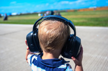 Caucasian Child Wearing Hearing Protection At An Airshow