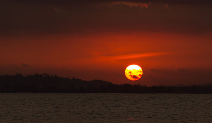 The sun almost hidden! Sunset time over the sea at Sumatra, Indonesia