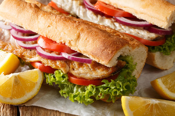 fast food sandwich balik ekmek with grilled mackerel served with lemon closeup. horizontal