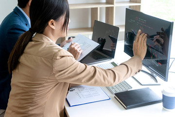 Poster - business man and woman sit at the table looking at computer