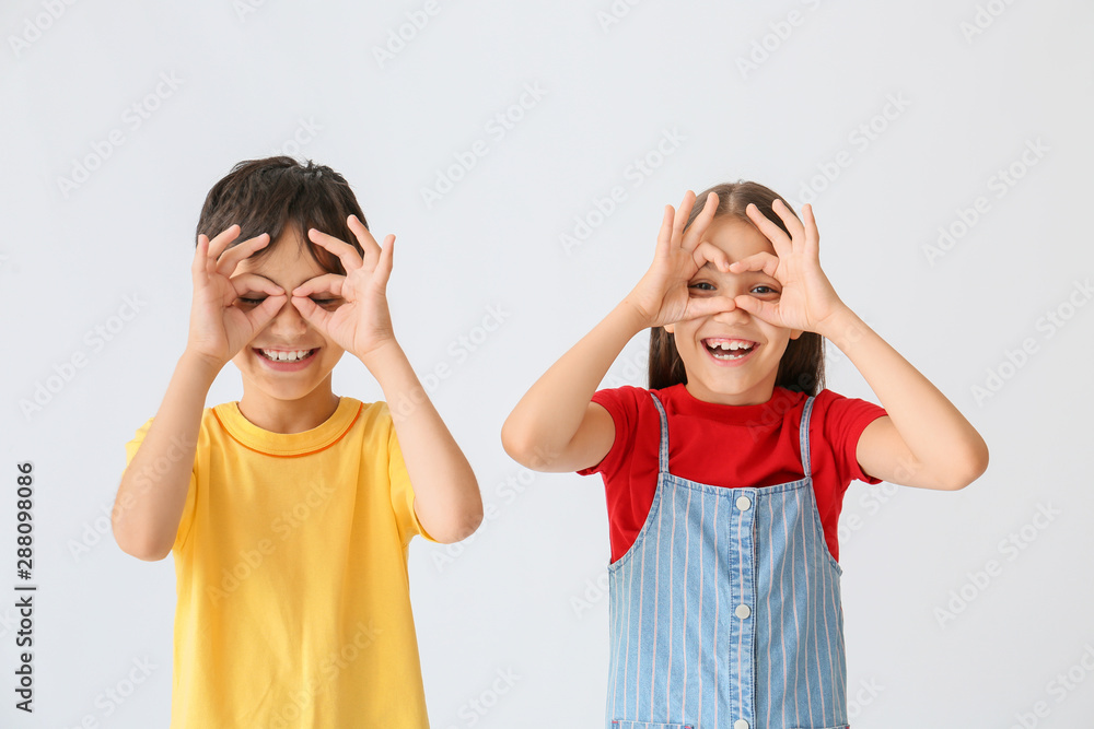 Portrait of cute children having fun on light background