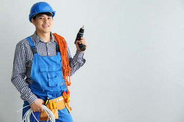 Male electrician on white background