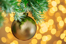 Christmas Tree Background With Golden Bauble On Bokeh Sparkling