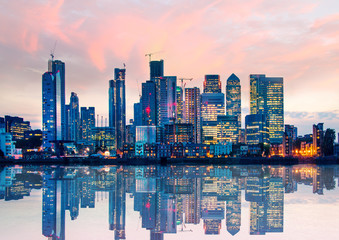 Wall Mural - Canary Wharf business and banking area at sunset with beautiful reflection in the River Thames water. London, UK