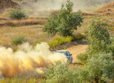 Fototapeta Sawanna - Sports Car on a Bend and a lot of Dust 05