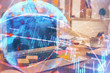 © peshkova - Double exposure of chart and financial info and work space with computer background. Concept of international online trading.