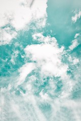 Wall Mural - Beautiful white soft fluffy clouds on a cold green sky background