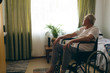 © WavebreakMediaMicro - Male patient  looking outside the window while sitting in wheelchair