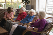© WavebreakMediaMicro - Group of senior friends interacting with each other at nursing home