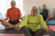 © WavebreakMediaMicro - Senior people doing yoga in fitness studio