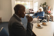 © WavebreakMediaMicro - Side view of senior man drinking coffee on dining table