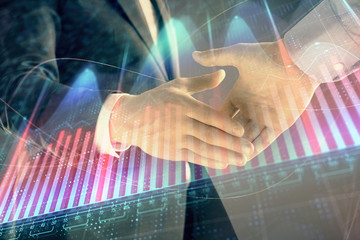 Multi exposure of forex graph on abstract background with two businessmen handshake. Concept of success on stock market