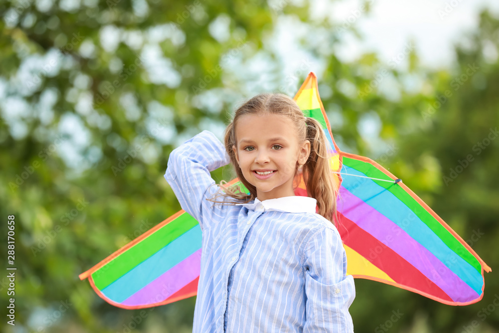 Little girl flying kite outdoors