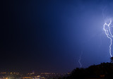 Fototapeta Tęcza - Lightning strike in the city Kyiv.. Storm outside. Thunderstorm with lightning in the city. Moment lightning