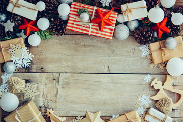 Wall Mural - Christmas background with gift boxes and decorations on the wood