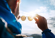 © Soloviova Liudmyla - Backpacker man looking at bright sun through polarized sunglasses  enjoying mountain landscape. Eye & Vision Care human health concept image.