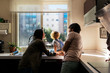 © Santi Nunez/Stocksy - Adorable happy family playing at the kitchen