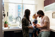© Santi Nunez/Stocksy - Adorable happy family playing with toys at home