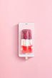 © Yaroslav Danylchenko/Stocksy - Colorful berries milk ice-cream with a modern smartphone on a light pink background. Flat lay.